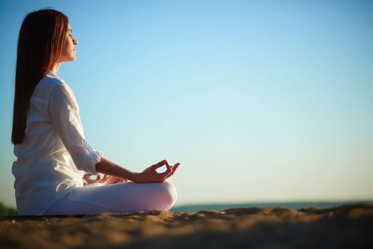 A woman sitting calmly and looking toward the horizon